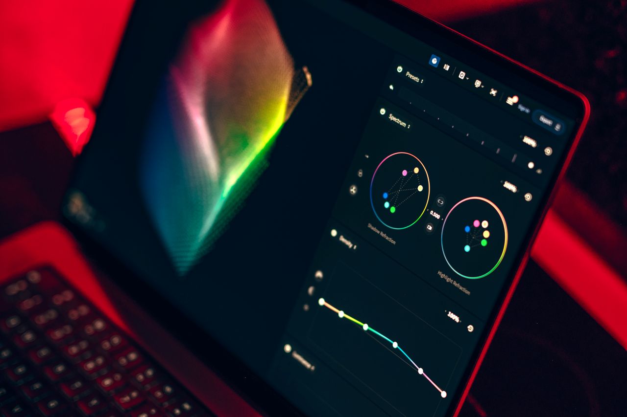 Services A close-up shot of a laptop displaying a color grading dashboard with vibrant colors.