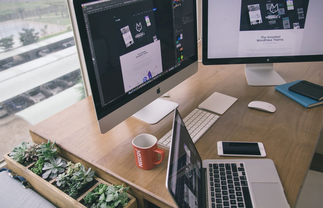 About Sleek office desk setup featuring Apple computers and greenery for a modern work environment.