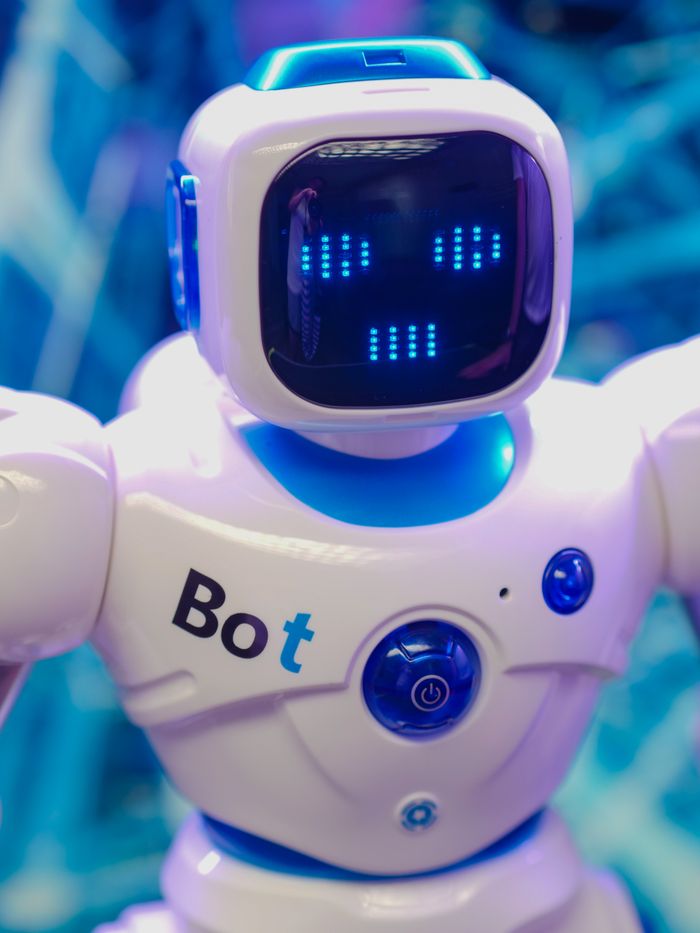 Crafting Captivating Headlines: Your awesome post title goes here White humanoid robot toy with illuminated face display representing modern technology.